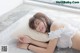 A woman laying on the floor with a pillow.