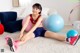 A young girl sitting on the floor with her legs crossed.